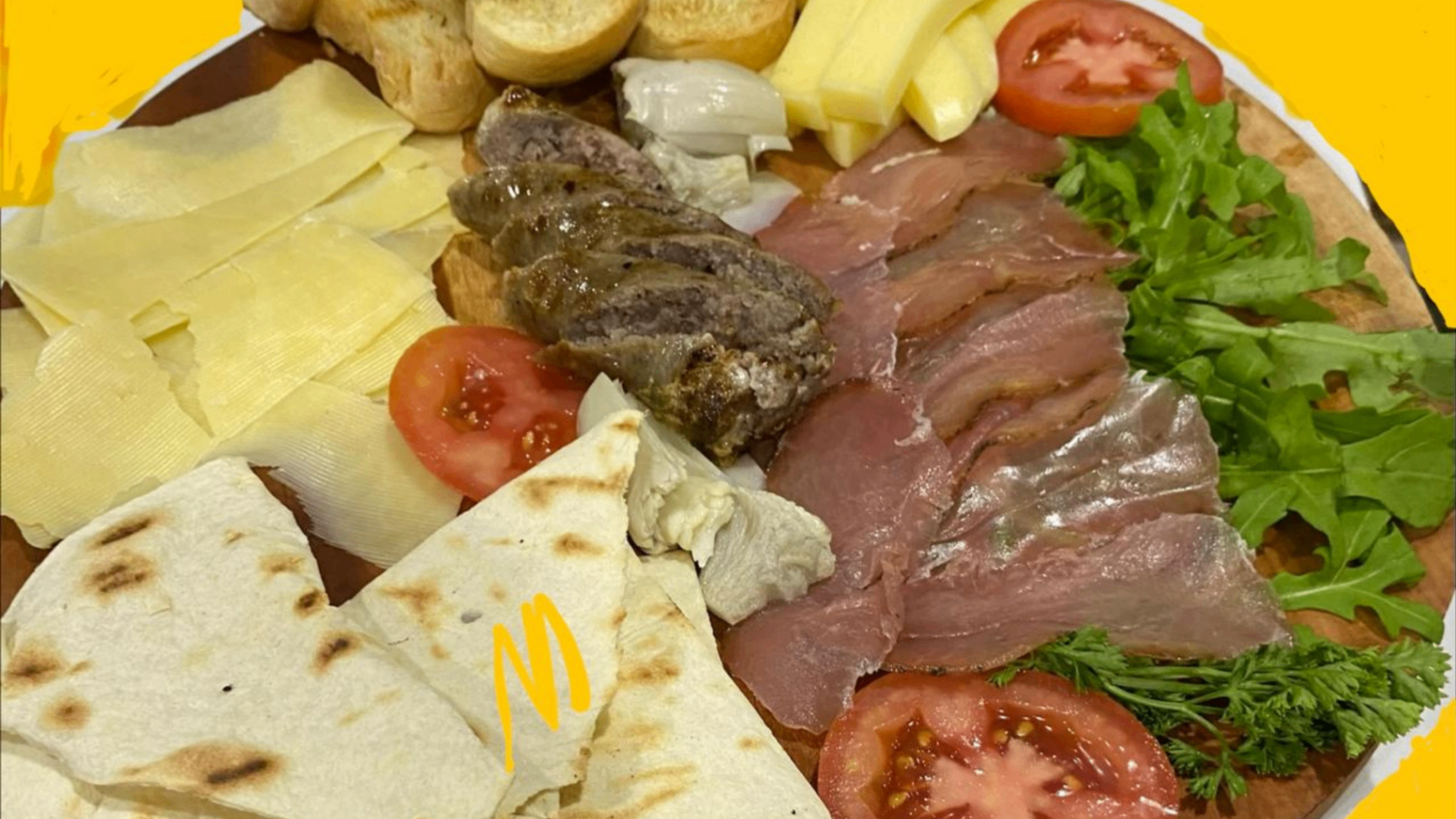 Antipasto board with cured meats, cheeses and bread