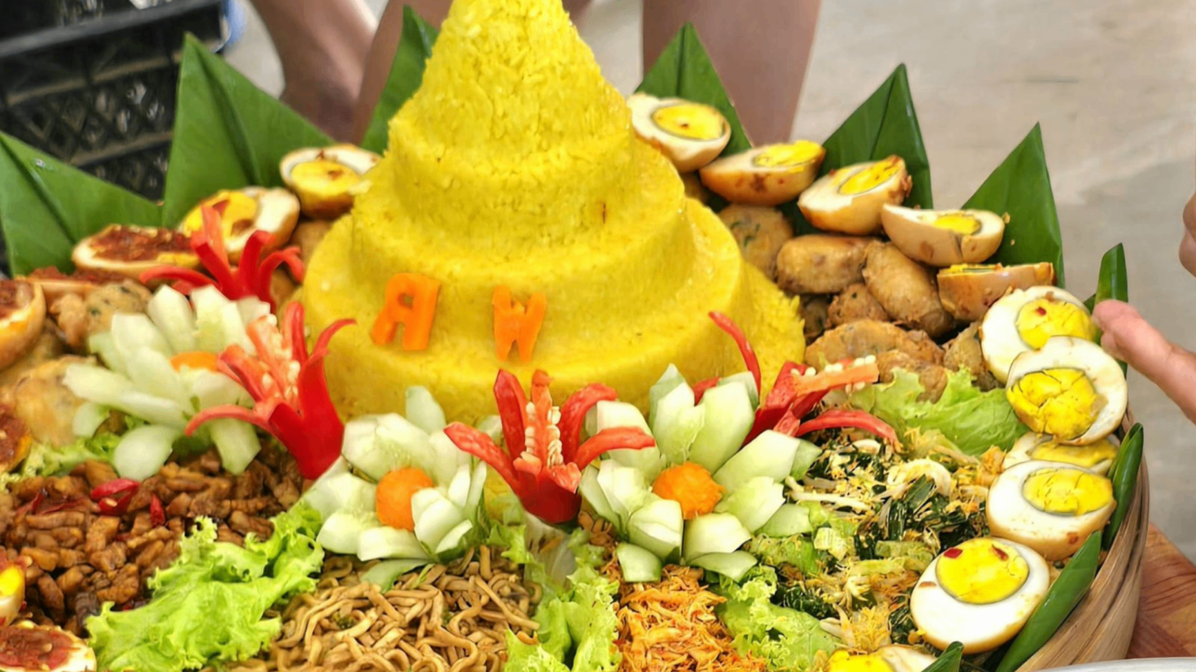 Traditional Balinese tumpeng rice cone with sides
