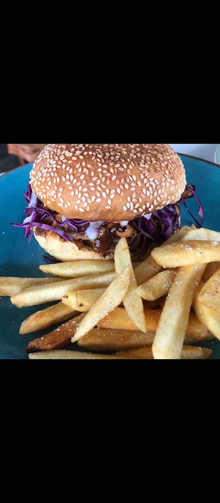 Pulled pork burger with sesame bun and fries